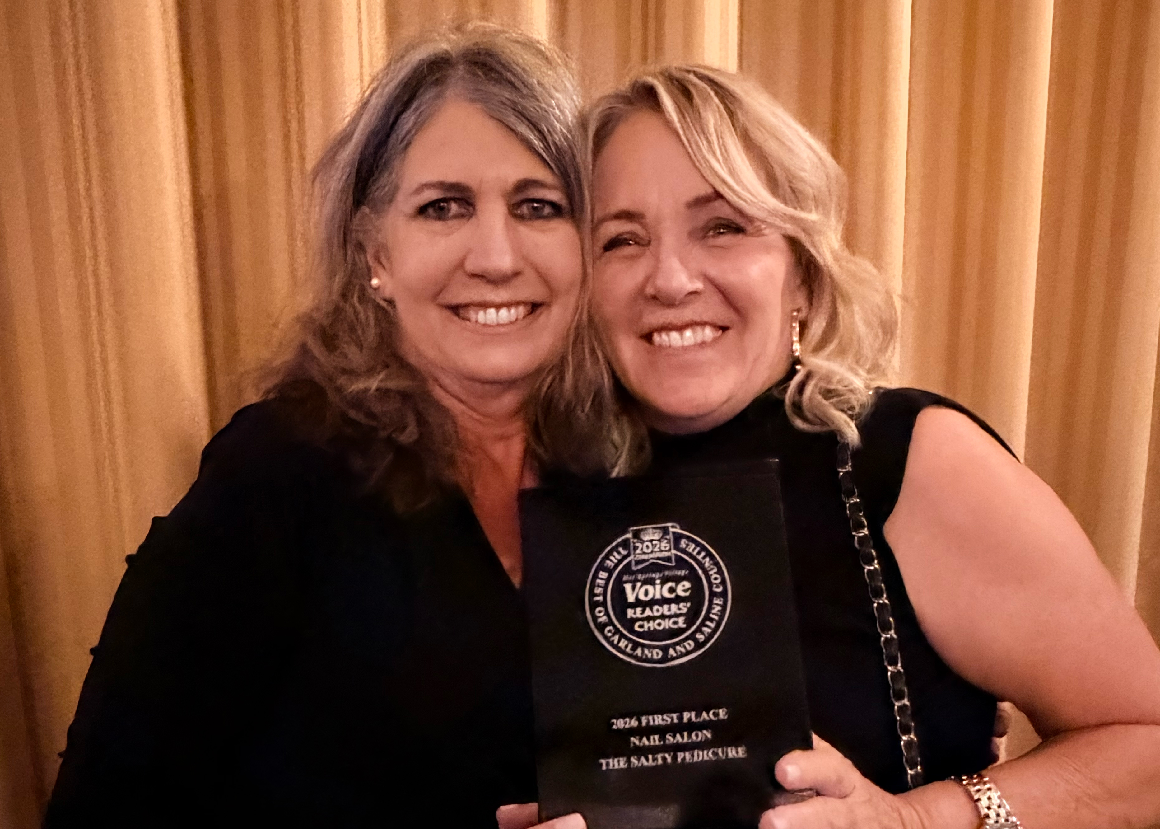 Russtina Green and Tammy Elmore holding their Readers' Choice Award for Best Nail Salon